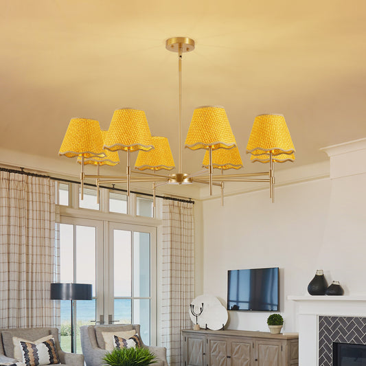 Gold Boho Rattan Chandelier with 8 yellow rattan lampshades installed in a cozy living room with a fireplace and large windows.