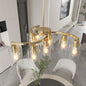 Modern Farmhouse 9-light chandelier in gold finish with clear glass shades, adjustable height, dimmable, ideal for dining room or kitchen island.