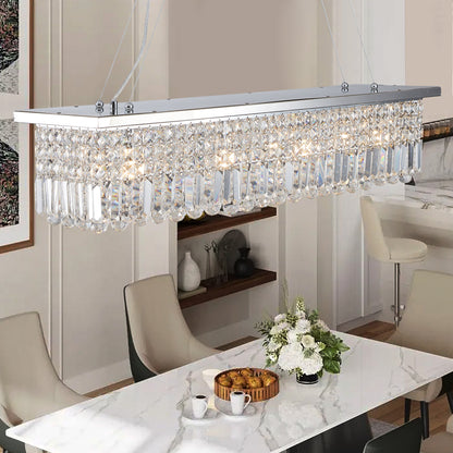 Close-up of 39.4-inch rectangle crystal raindrop chandelier with 8 lights, chrome finish, in dining space with marble table