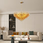 Gold round tiered chandelier hanging in modern living room with neutral decor, 14-light design.