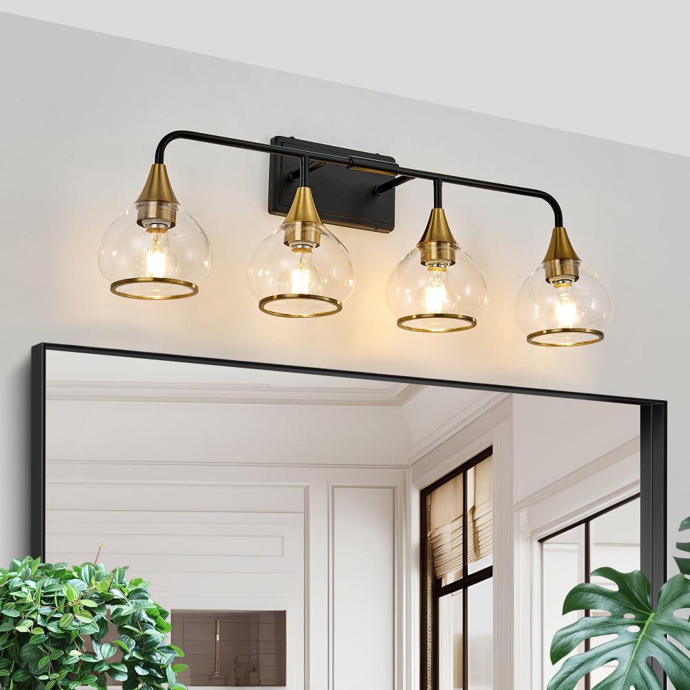 Black and gold industrial vanity wall sconce with four clear glass shades above a large mirror.