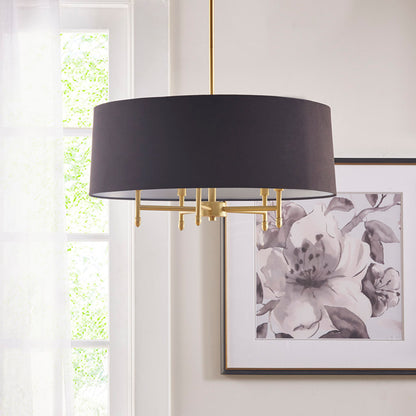 Black 5-light drum shade chandelier with gold plated brass frame, hanging in a bright room with a window and framed floral artwork.