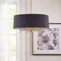 Black 5-light drum shade chandelier with gold plated brass frame, hanging in a bright room with a window and framed floral artwork.