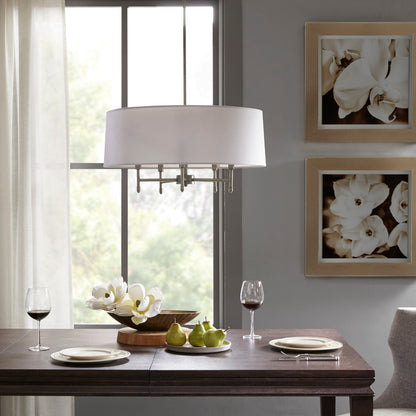 5-light drum shade chandelier with white cotton-linen shade and silver plated brass frame, hanging over dark wood dining table with plates, wine glasses, and floral centerpiece.