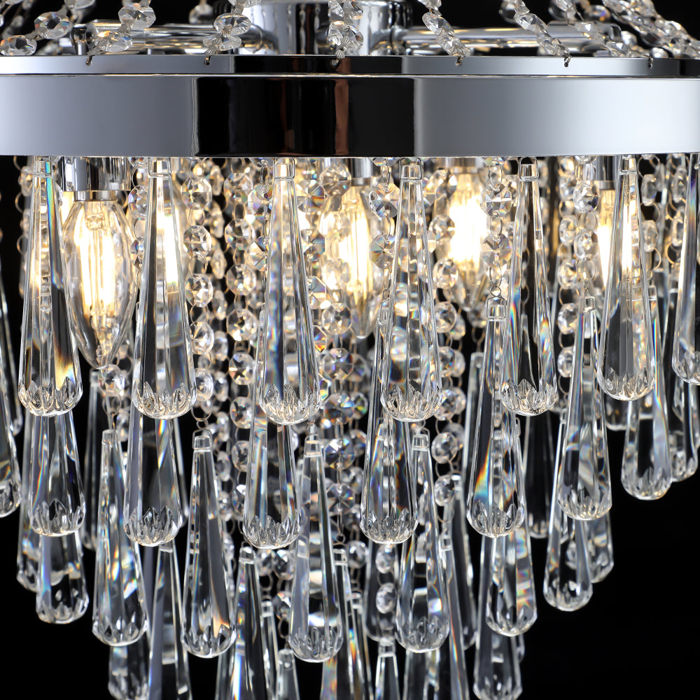 Close-up of 20" K9 crystal chandelier featuring crystal teardrops, chrome frame, and illuminated bulbs.