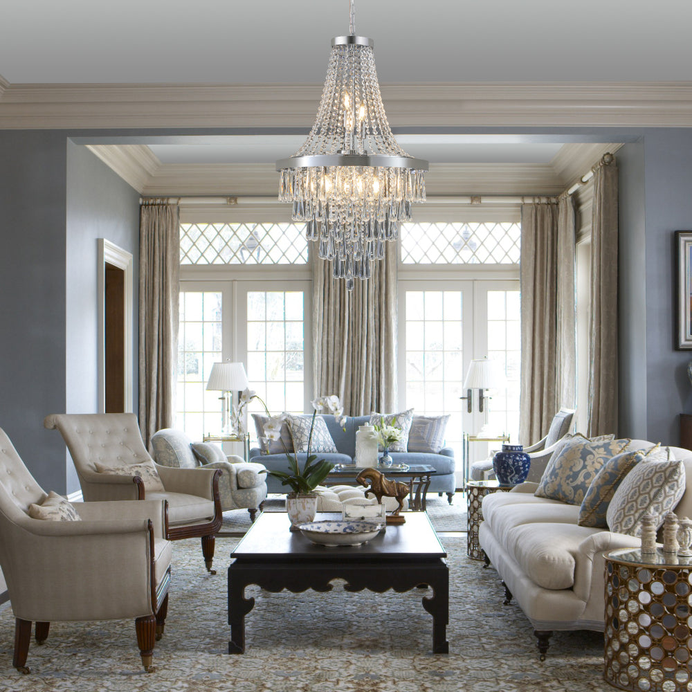 20-inch K9 crystal chandelier with chrome finish, 11 lights, adjustable height 33-71 inches, hanging in a bright living room with large windows, light blue sofa, and neutral decor.