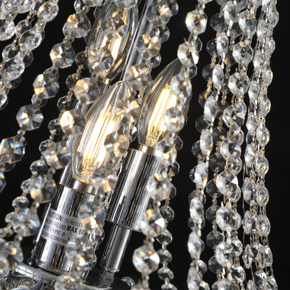 Close-up of 20" K9 crystal chandelier with chrome finish, lit filament bulbs, and sparkling crystal drops.