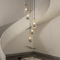 5-light raindrop cluster pendant chandelier with hand-blown glass, gold finish, adjustable length, hanging in modern stairwell