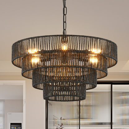Black hemp rope chandelier with 4-tier design, lit bulbs, hanging in a kitchen or dining area with glass doors.