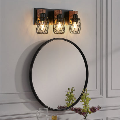 Industrial black metal cage wall sconce with wood accents, 3-light vintage fixture mounted above round bathroom mirror with floral arrangement