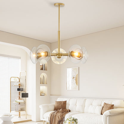 Gold sputnik chandelier hanging in a bright living room with white sofa, beige walls, and decorative shelves, featuring clear glass shades and warm lighting