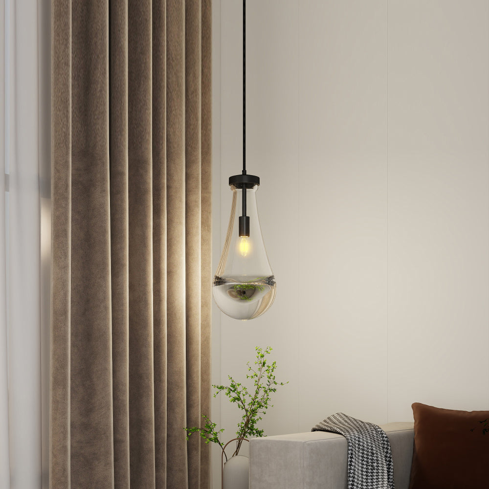 Raindrop Pendant Light featuring hand-blown clear glass shade and black rod, illuminated near brown curtains in a living room.