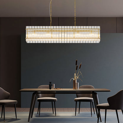 Rectangular Water Ripple Crystal Glass Chandelier in gold, hanging over modern dining table with dark walls.