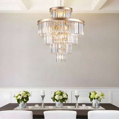 23.6-inch 5-tier K9 crystal chandelier with gold frame above a dining table with white chairs and green floral centerpieces
