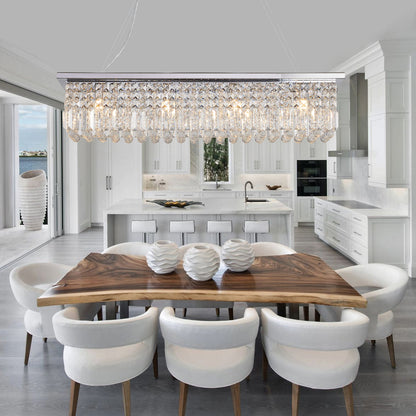 39.4-inch rectangle crystal raindrop chandelier with 8 lights, chrome finish, hanging over wooden dining table in bright kitchen