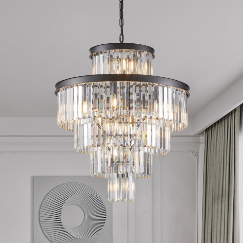 23.6-inch 5-tier K9 crystal chandelier with 15 lights, black frame, hanging in a modern living room with white walls, a circular mirror, and curtains.