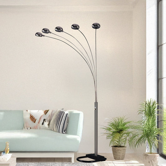 Modern floor lamp with multiple light heads in a living room setting.