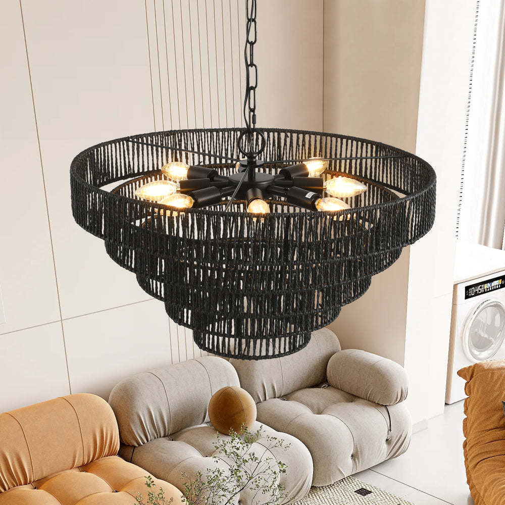 4-tier black hemp rope chandelier with lit E12 bulbs, hanging in a living room with beige and tan sofas.