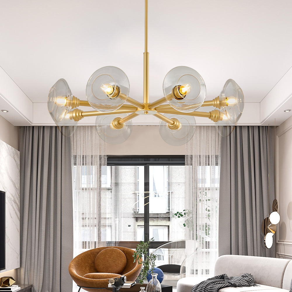 Gold mid-century modern sputnik chandelier with 8 clear glass shades in a living room with gray curtains and brown armchair