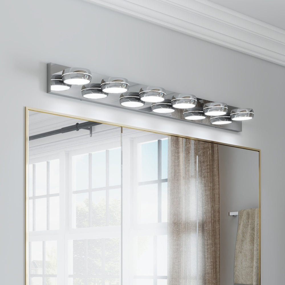 Modern chrome 6-light LED vanity light bar, 43 inches, mounted above a gold-framed bathroom mirror with bright, even illumination