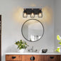 Industrial black metal cage wall sconce with wood accents, 3-light vintage fixture above round bathroom mirror with marble countertop and wooden vanity