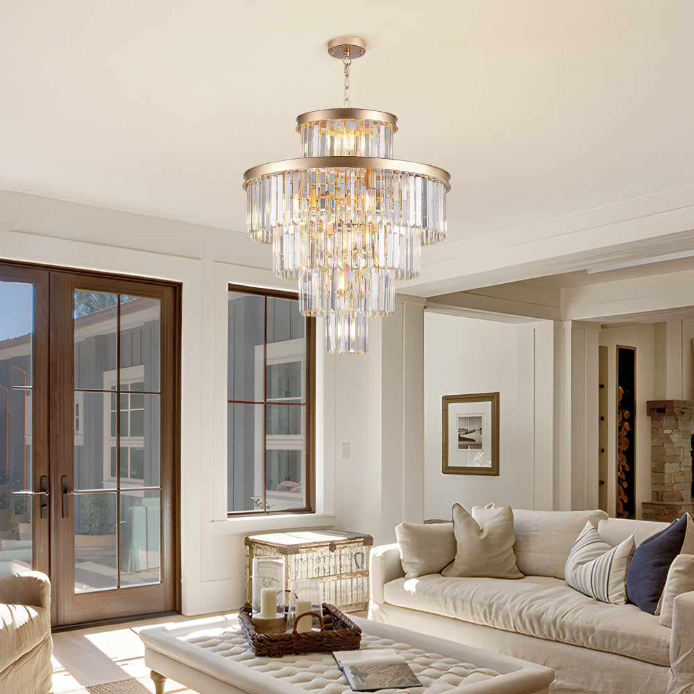 23.6-inch 5-tier K9 crystal chandelier with gold frame in a living room with sliding glass doors, beige sofa, and tufted ottoman