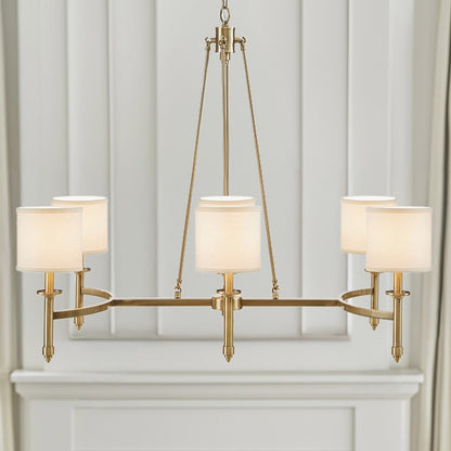 Gold 6-light drum shade chandelier with curved frame, transitional style, 39.25 inches wide, Bedford Collection, installed in room with paneled wall and mantel.