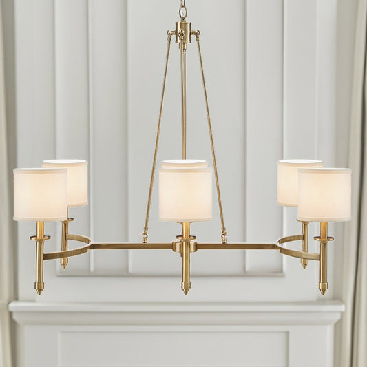 Gold 6-light drum shade chandelier with curved frame, transitional style, 39.25 inches wide, Bedford Collection, installed in room with paneled wall and mantel.