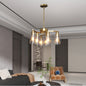 Modern Farmhouse 6-light chandelier in gold finish with clear glass shades, adjustable height, dimmable, perfect for dining room or kitchen island.