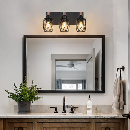 Industrial black cage wall sconce with wood accents, 3-light vintage fixture above bathroom vanity mirror with marble countertop and greenery