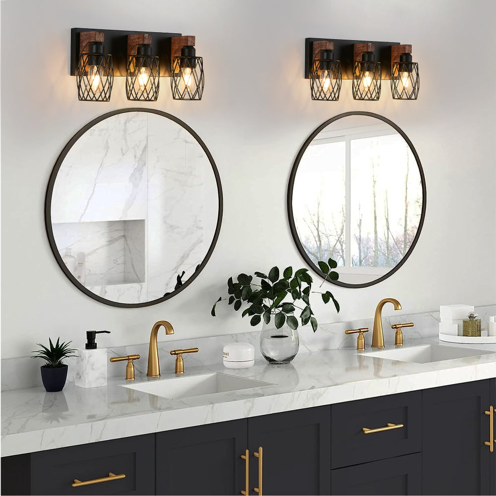 Pair of industrial black cage wall sconces with wood accents, 3-light vintage fixtures above double bathroom vanity with round mirrors and marble countertop