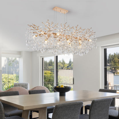 Gold Tree Branch Crystal Chandelier with gold branches and crystal accents, hanging in a bright dining room with large windows and natural light.