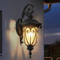 23-inch black vintage outdoor wall lantern with bubble glass, weatherproof design, mounted on a wall, illuminating porch or entryway.