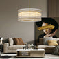 Round water ripple crystal glass chandelier with gold metal frame, 8/10 lights, modern handmade design, in a stylish living room with neutral tones and abstract art