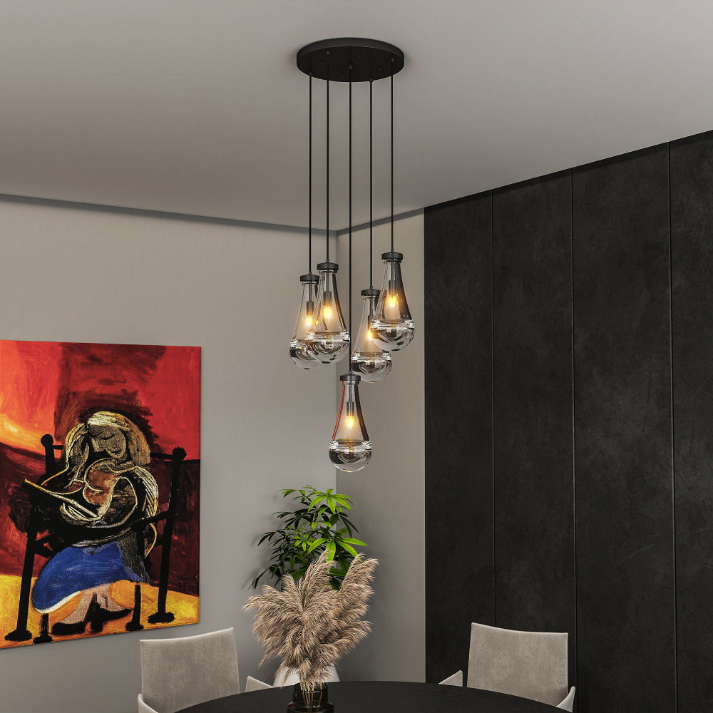 Raindrop Cluster Pendant Chandelier with 7 hand-blown glass pendants, black cord, in a modern dining room with dark wall and colorful abstract painting.