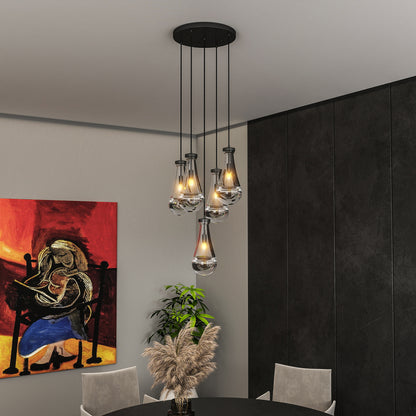 Raindrop Cluster Pendant Chandelier with 7 hand-blown glass pendants, black cord, in a modern dining room with dark wall and colorful abstract painting.